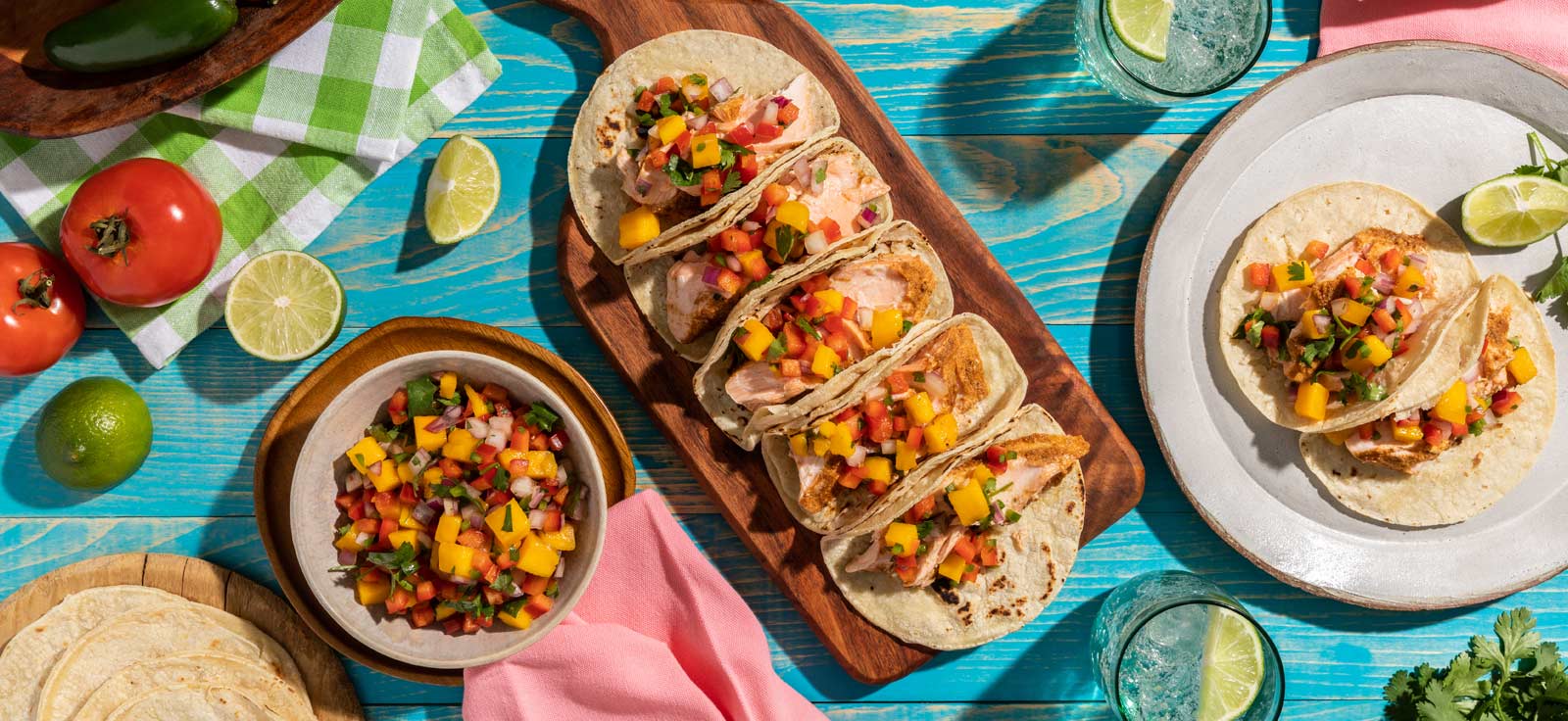 plates of food inclusing salmon tacos and mango salsa